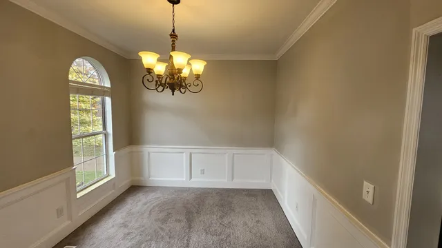 a view of a room with window and chandelier fan