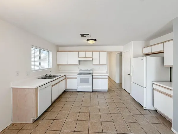 a kitchen with a stove sink and a refrigerator