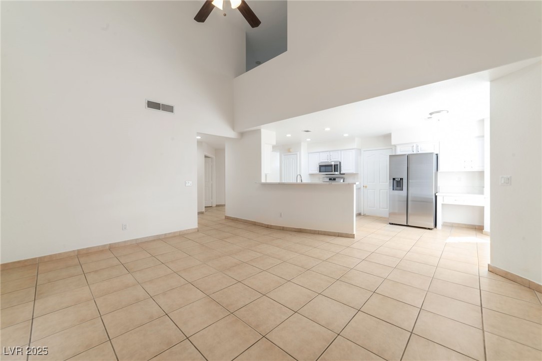 121 Golf Course Street Las Vegas, NV 89145 - Photo 3 of 15 Unfurnished living room featuring light tile patte