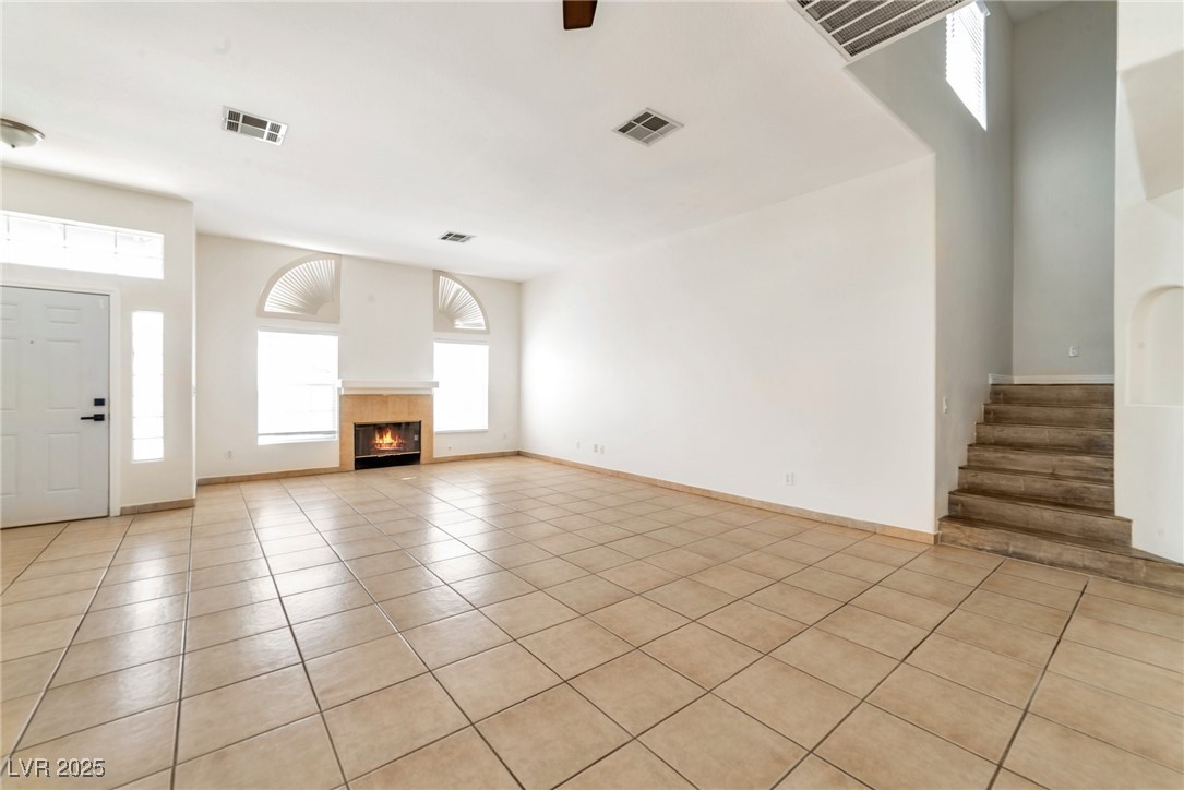 121 Golf Course Street Las Vegas, NV 89145 - Photo 4 of 15 Unfurnished living room featuring a tiled fireplac