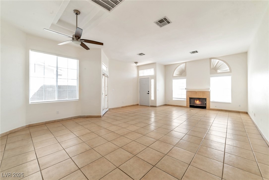 121 Golf Course Street Las Vegas, NV 89145 - Photo 8 of 15 Unfurnished living room featuring a fireplace, lig