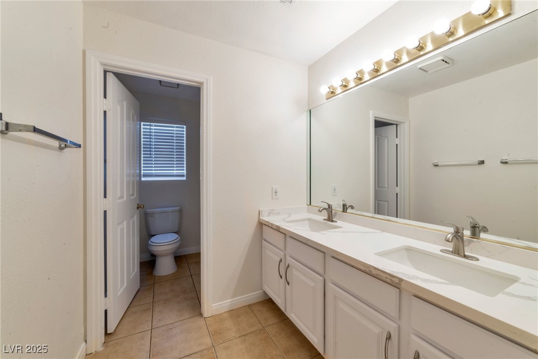 121 Golf Course Street Las Vegas, NV 89145 - Photo 9 of 15 Bathroom with a sink, toilet, double vanity, and t