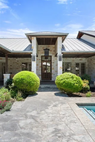 a view of house with swimming pool outdoor seating and garden