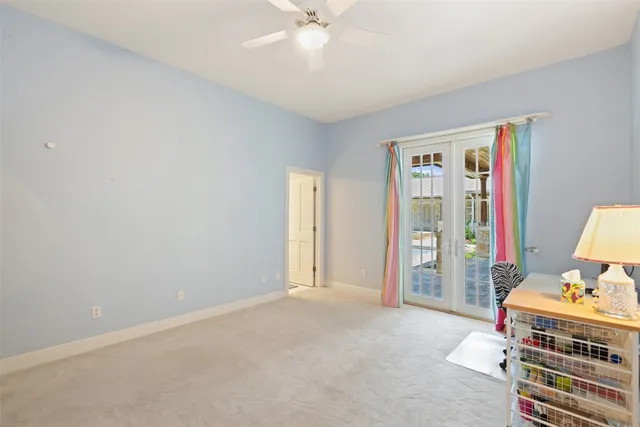 a bedroom with a bed and a flat tv screen on dresser