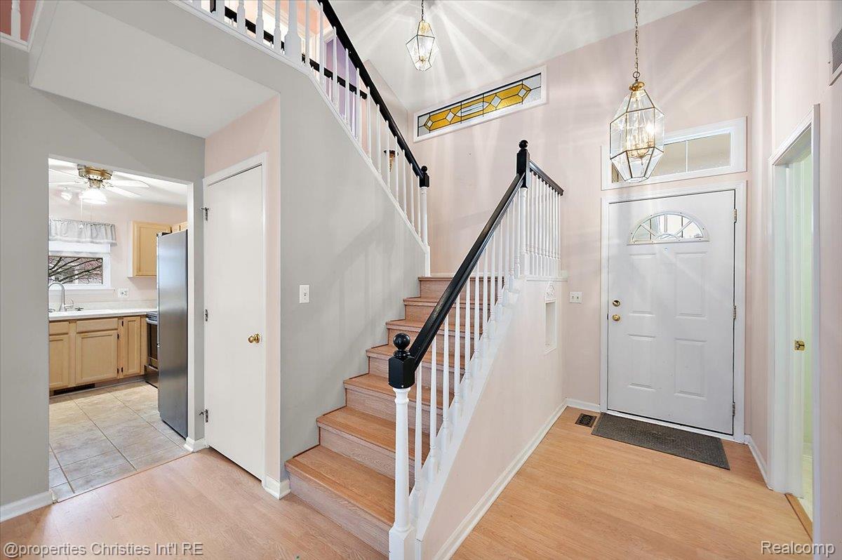 955 Rikki Ann Court Wixom, MI 48393 - Photo 21 of 54 Entryway featuring light wood-style floors, suspended lighting, and a ceiling fan