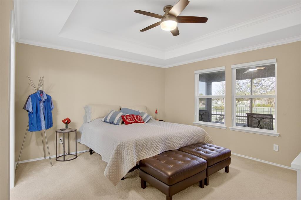 8978 Shore Crest Road Frisco, TX 75036 - Photo 14 of 40 a bedroom with a bed and a chandelier