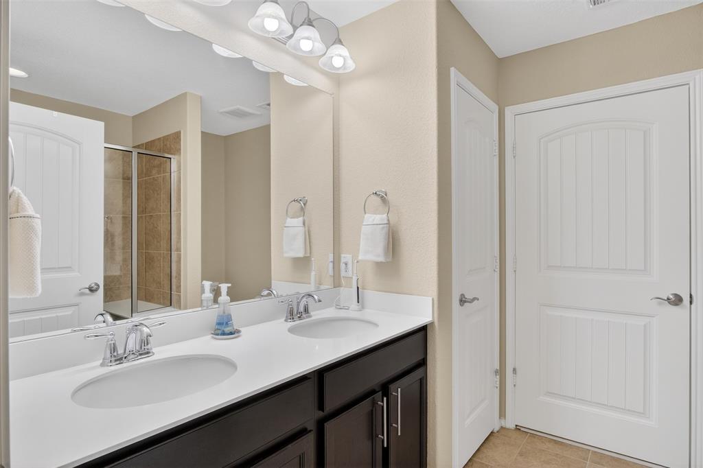 8978 Shore Crest Road Frisco, TX 75036 - Photo 16 of 40 a bathroom with a sink double vanity and a mirror