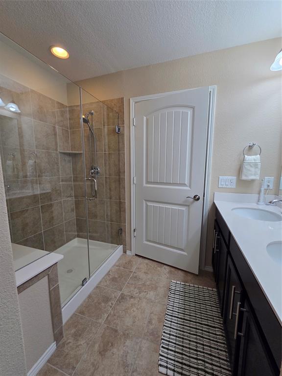 8978 Shore Crest Road Frisco, TX 75036 - Photo 17 of 40 a bathroom with a shower and a sink