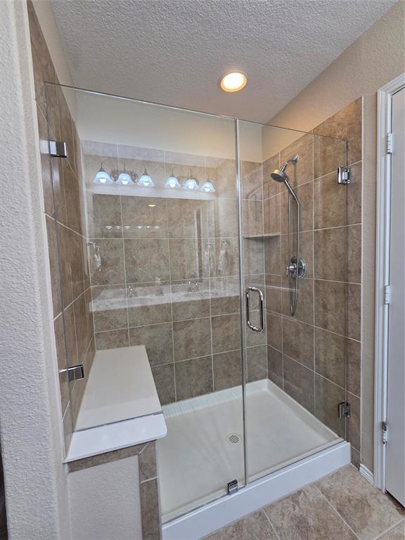 8978 Shore Crest Road Frisco, TX 75036 - Photo 18 of 40 a bathroom with a shower and bathtub