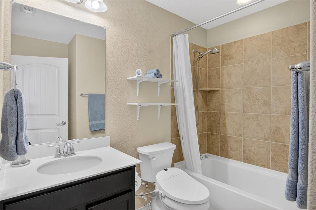 8978 Shore Crest Road Frisco, TX 75036 - Photo 22 of 40 a bathroom with a sink a toilet and shower