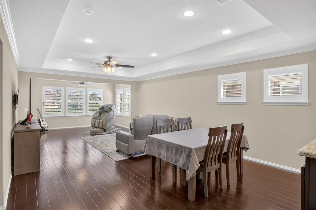 8978 Shore Crest Road Frisco, TX 75036 - Photo 9 of 40 a view of a dining room with furniture window and wooden floor