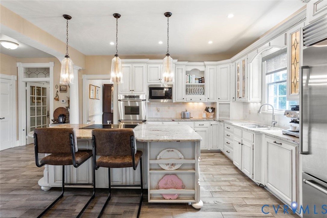 516 Mt Hermon Road Midlothian, VA 23112 - Photo 13 of 50 a kitchen with stainless steel appliances granite countertop a stove and refrigerator