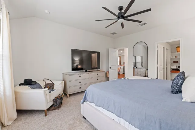 a spacious bedroom with a bed and a window