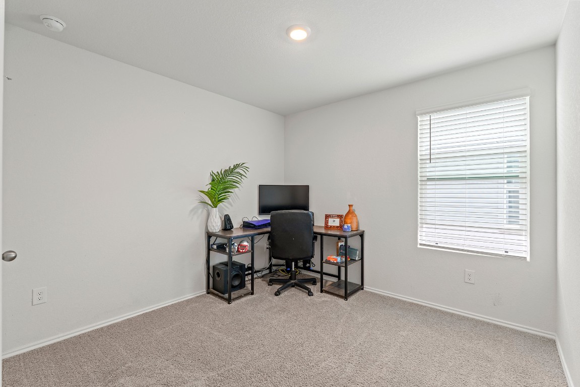 11817 Rush Lane Elgin, TX 78621 - Photo 19 of 30 a view of a workspace with furniture and a window