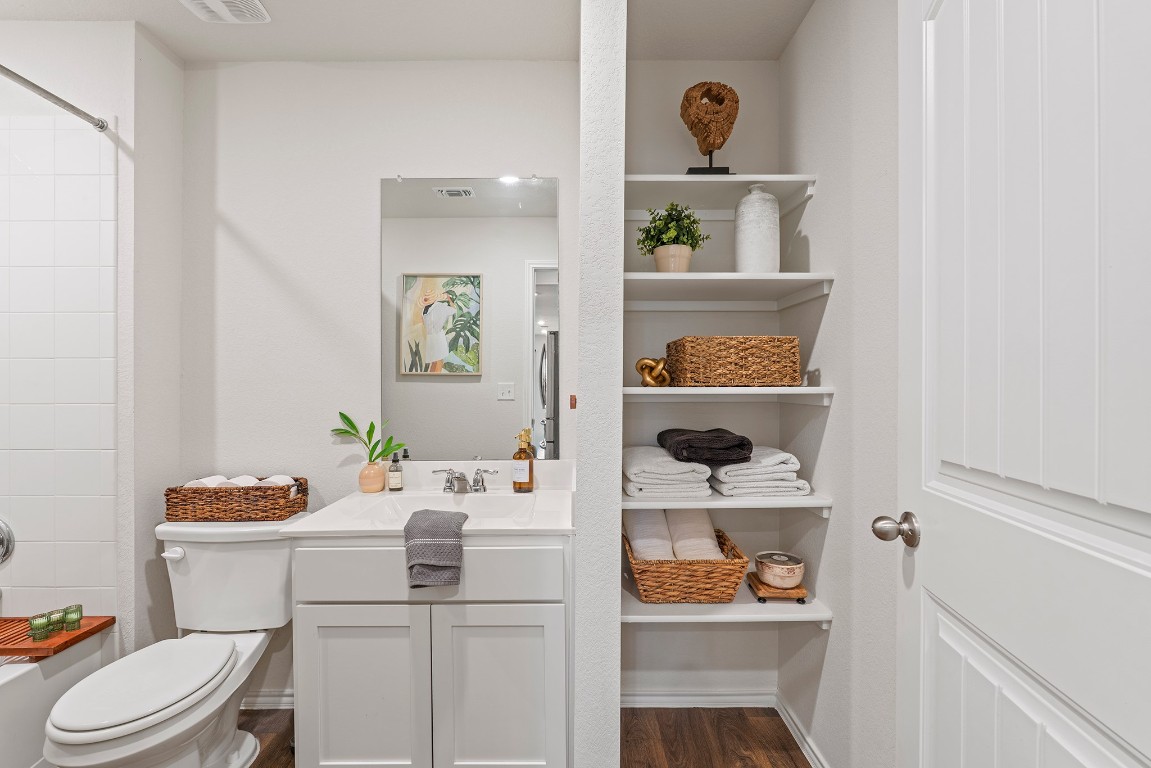 11817 Rush Lane Elgin, TX 78621 - Photo 23 of 30 a bathroom with a sink a toilet and a mirror