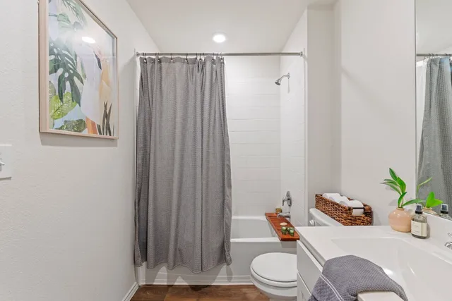 a bathroom with a sink a toilet and a mirror