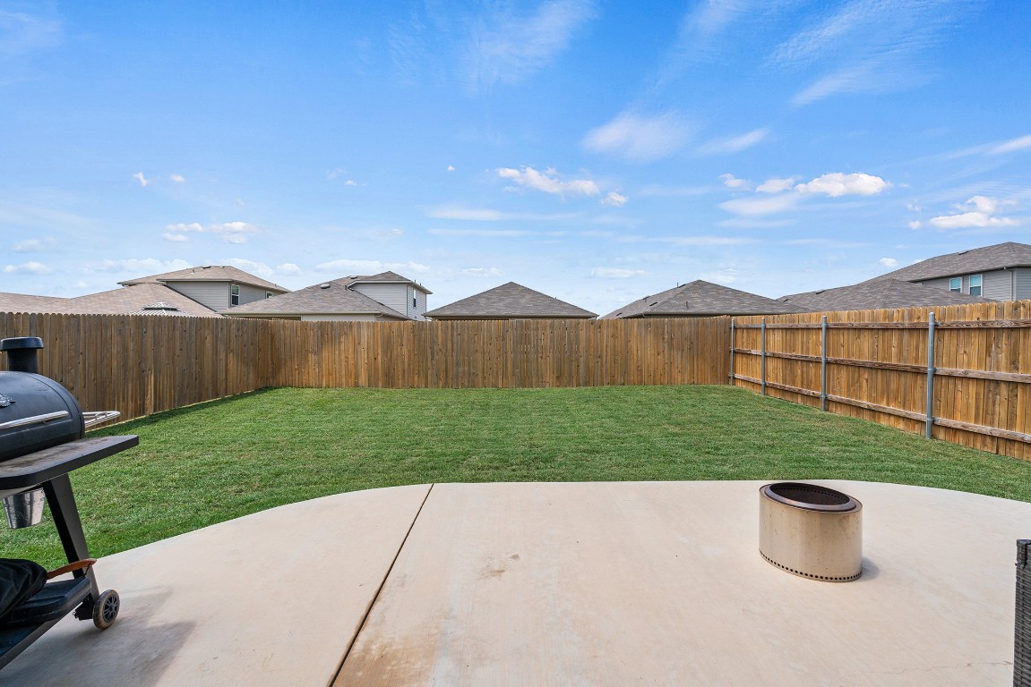 11817 Rush Lane Elgin, TX 78621 - Photo 27 of 30 a view of a backyard with table and chairs