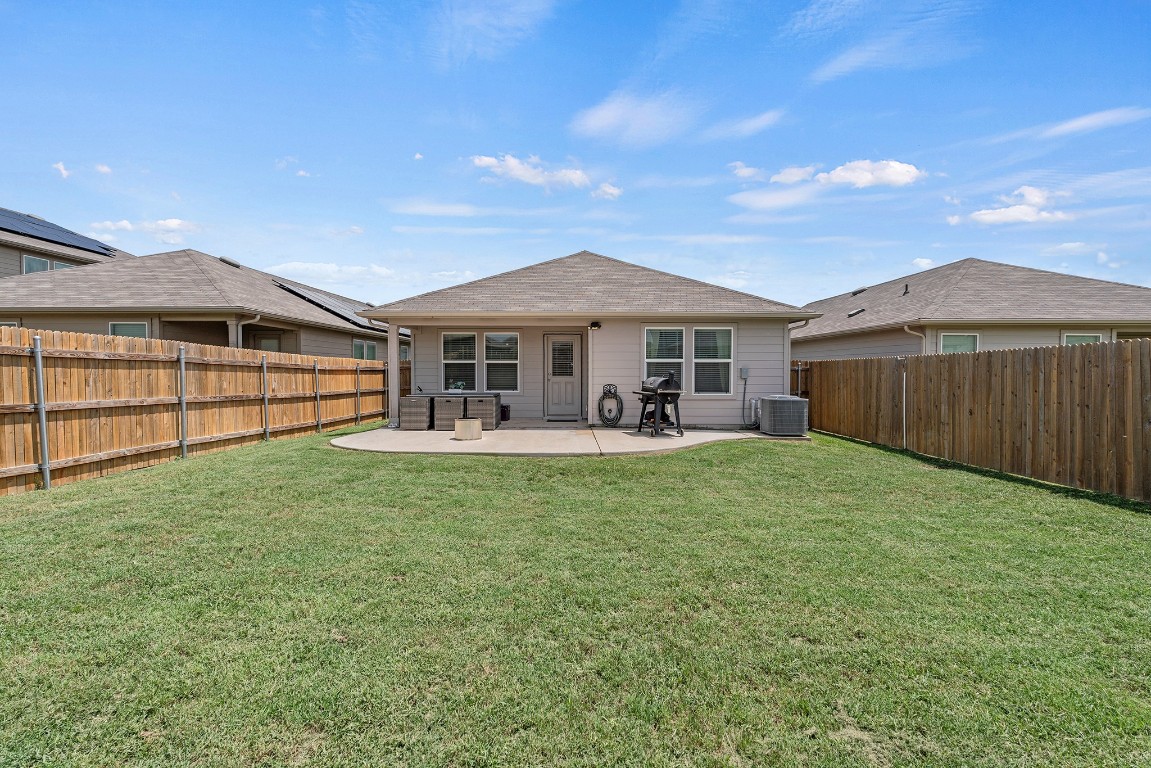 11817 Rush Lane Elgin, TX 78621 - Photo 29 of 30 a view of a house with a backyard and a patio