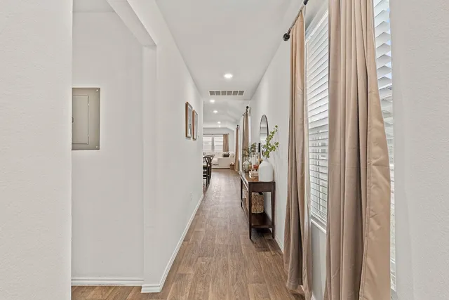 a view of a hallway with a livingroom with furniture