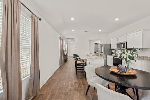 a view of a dining room with furniture and wooden floor