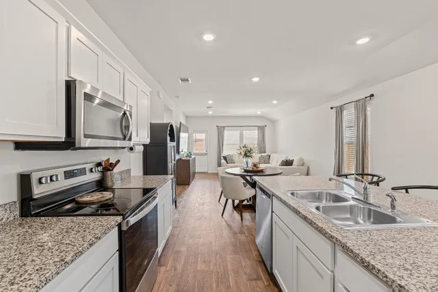 a view of a house with a backyard and a patio