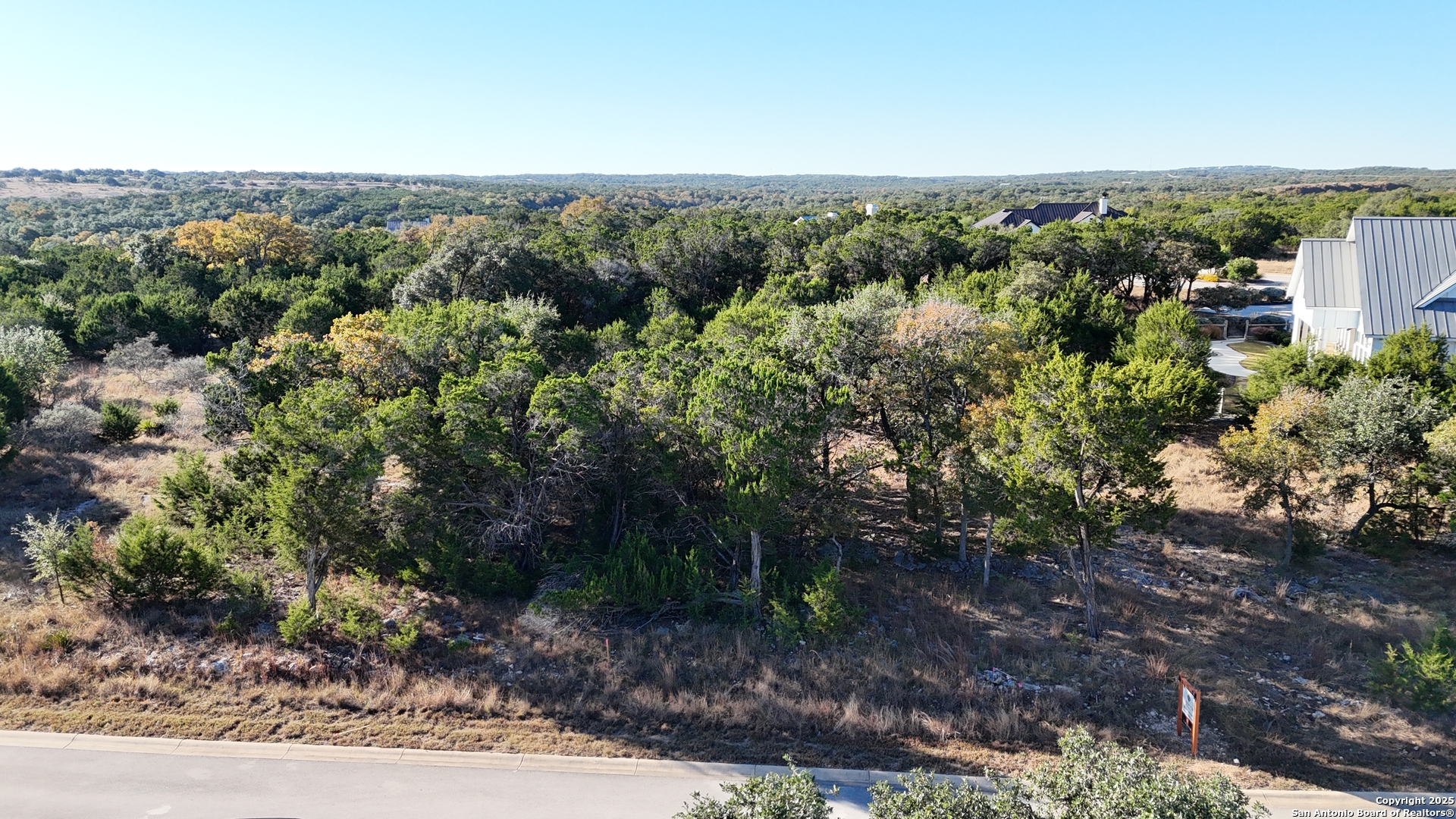 69 Ledgestone Place Boerne, TX 78006 - Photo 3 of 8 a view of a forest with a yard