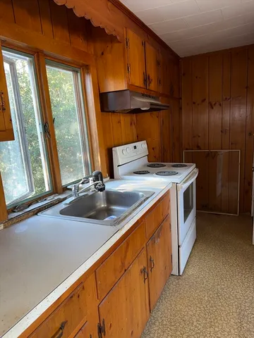 a kitchen that has a sink and a stove