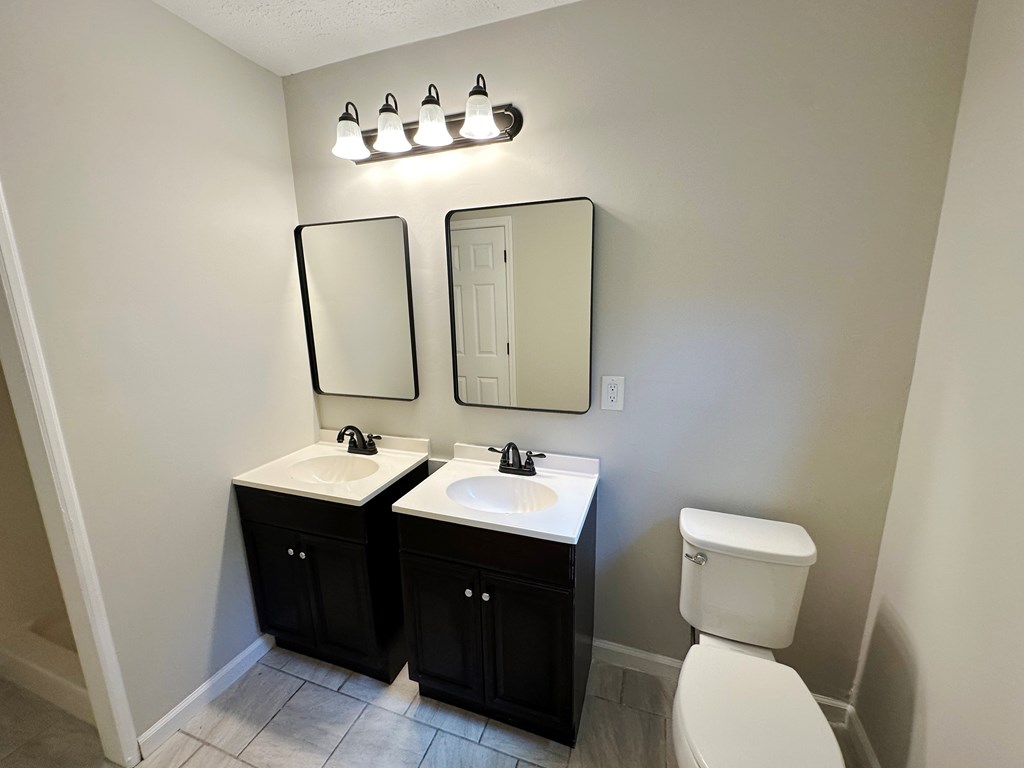 558 Macedonia Road Newnan, GA 30263 - Photo 34 of 44 a bathroom with a toilet sink and mirror