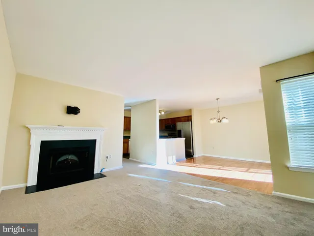 a view of a livingroom with a fireplace and window