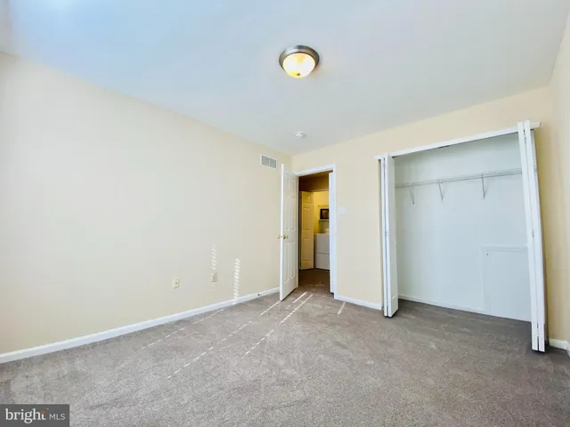 an empty room with a ceiling fan and a window