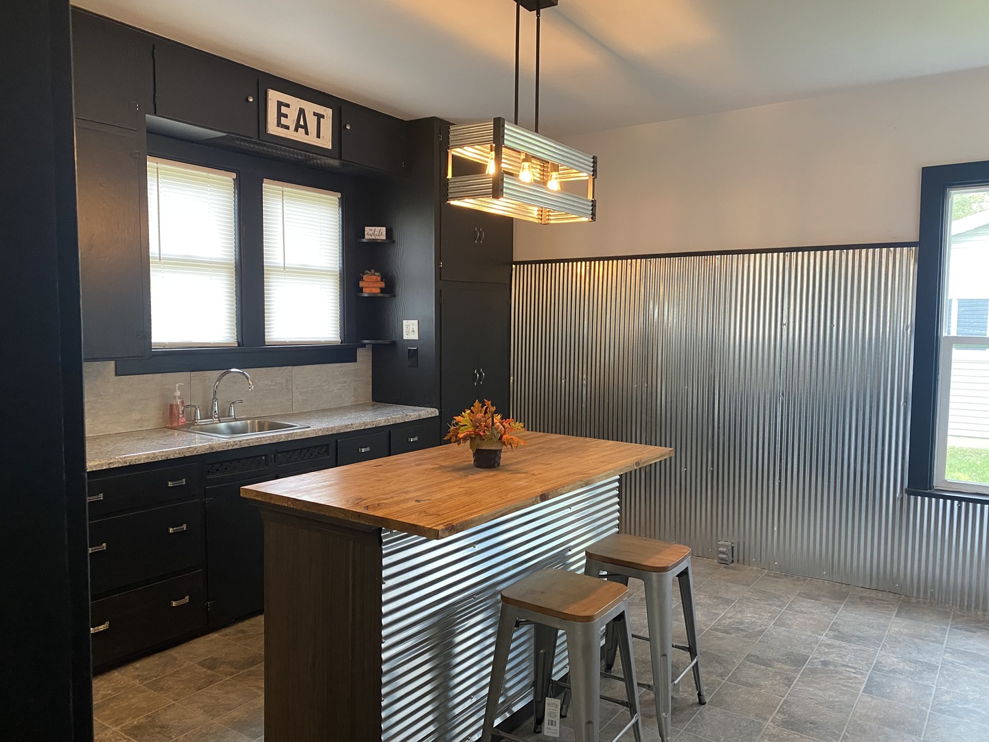 116 East Minnesota Street Spring Valley, IL 61362 - Photo 14 of 18 a dining room with a sink a chandelier and a table