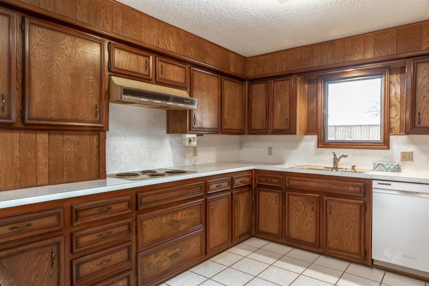 4424 76th Street Lubbock, TX 79424 - Photo 11 of 27 a kitchen with a sink window and cabinets