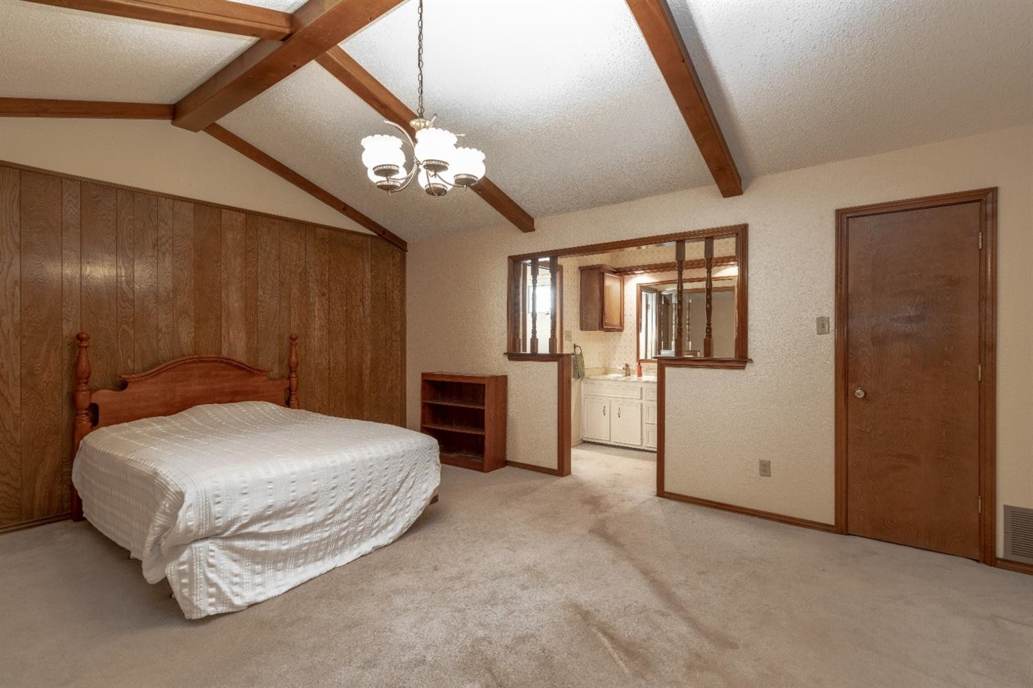 4424 76th Street Lubbock, TX 79424 - Photo 13 of 27 a spacious bedroom with a bed and a chandelier
