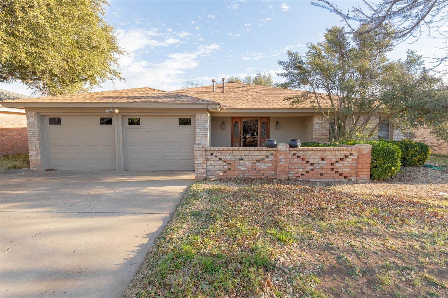 4424 76th Street Lubbock, TX 79424 - Photo 27 of 27 a front view of a house with a yard and garage