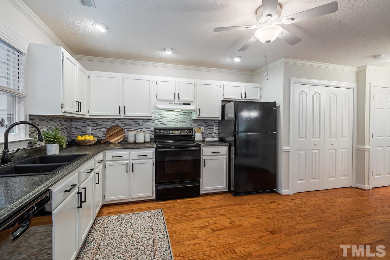 4109 Settlement Drive Durham, NC 27713 - Photo 17 of 31 a kitchen with granite countertop stainless steel appliances and wooden cabinets