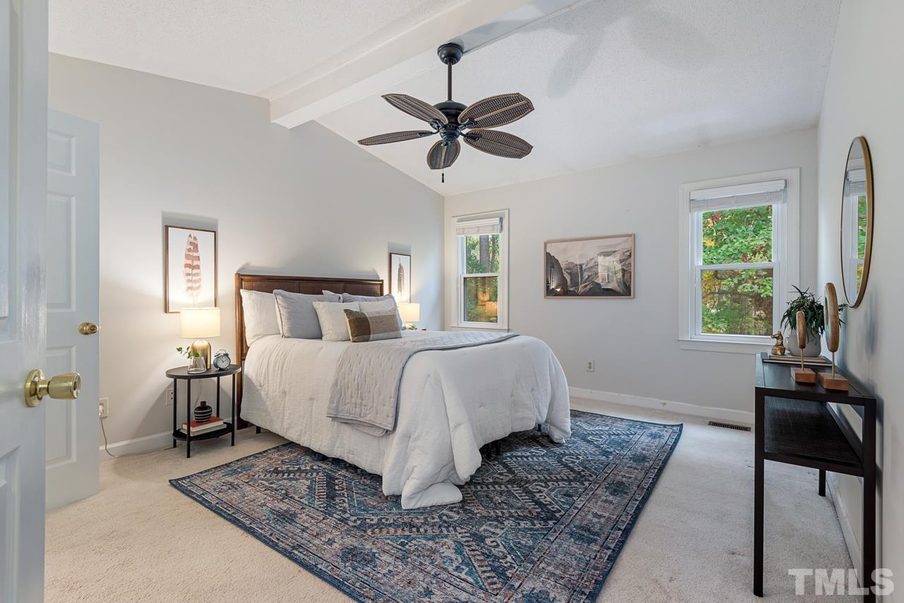 4109 Settlement Drive Durham, NC 27713 - Photo 21 of 31 a bedroom with a bed and a chandelier