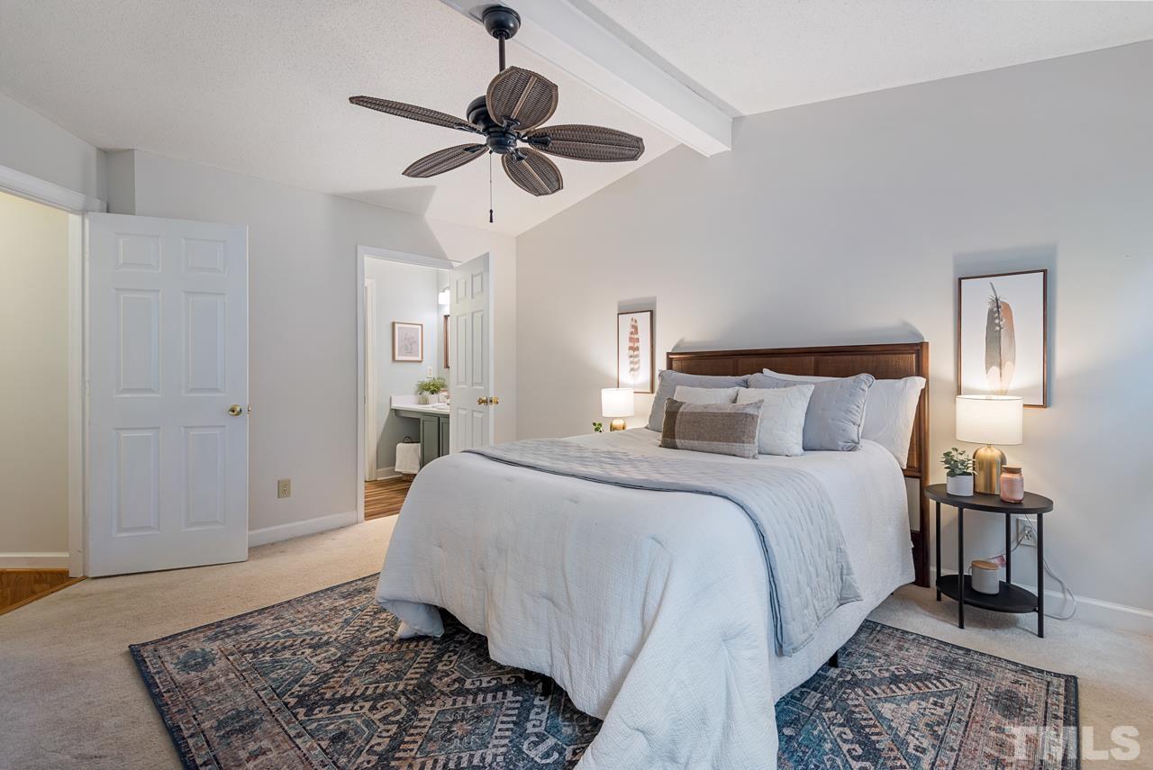 4109 Settlement Drive Durham, NC 27713 - Photo 22 of 31 a bedroom with a bed and a chandelier