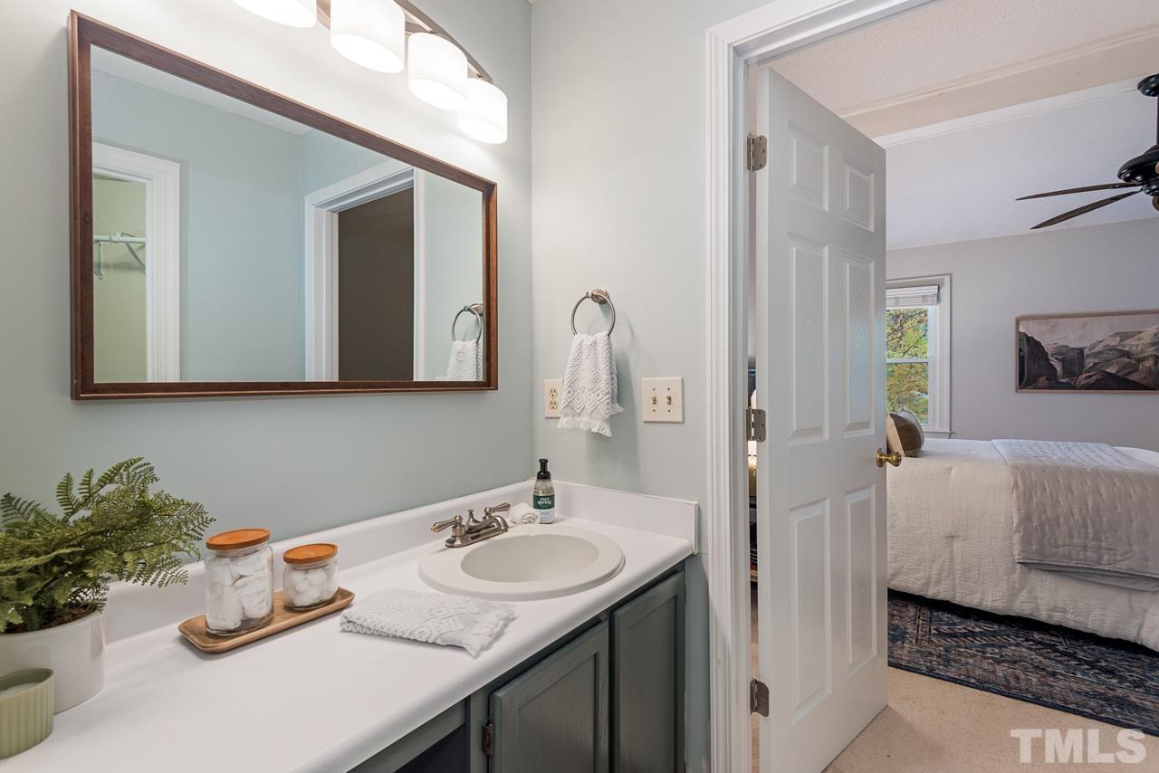 4109 Settlement Drive Durham, NC 27713 - Photo 23 of 31 a en suite bathroom with a sink and a mirror