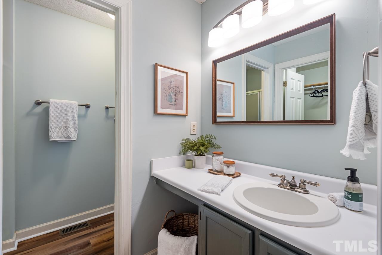4109 Settlement Drive Durham, NC 27713 - Photo 24 of 31 a bathroom with a sink and a mirror