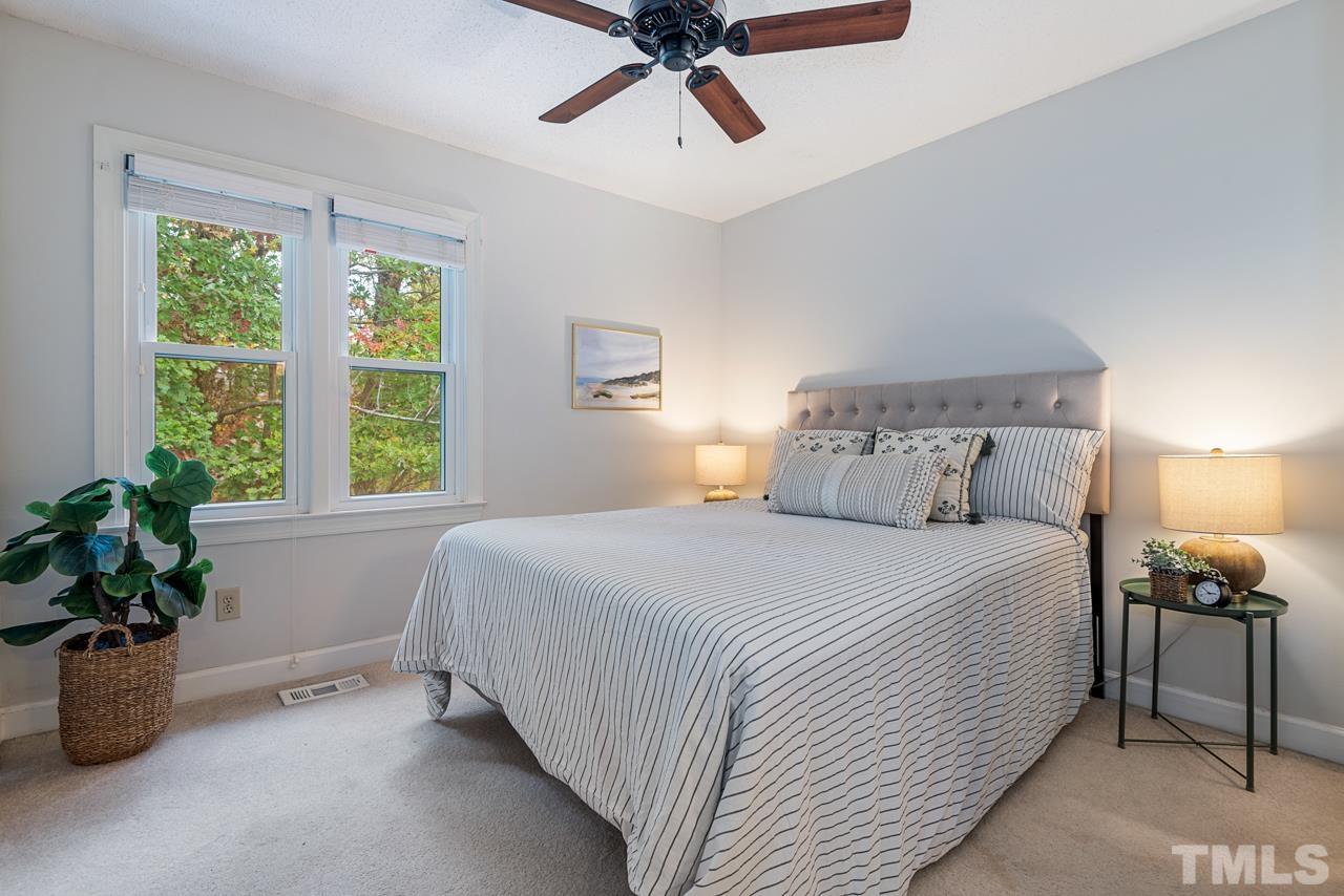 4109 Settlement Drive Durham, NC 27713 - Photo 26 of 31 a bedroom with a large bed and a potted plant