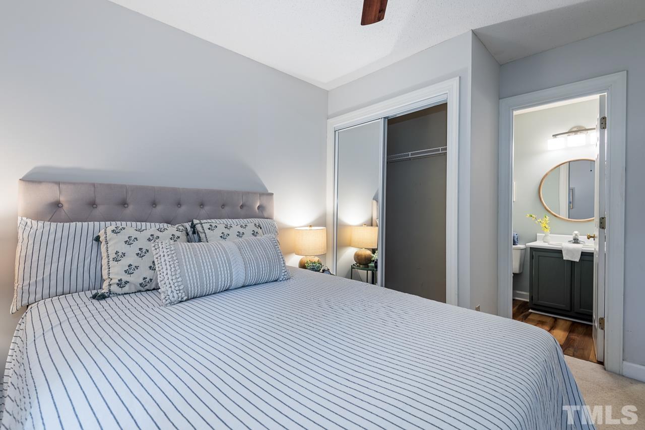 4109 Settlement Drive Durham, NC 27713 - Photo 27 of 31 a bedroom with a large bed and a chandelier