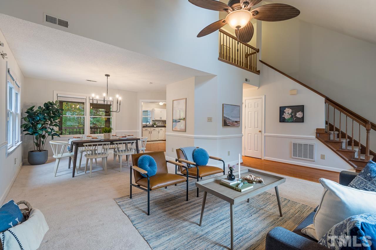 4109 Settlement Drive Durham, NC 27713 - Photo 6 of 31 a living room with furniture a chandelier a rug and a large window