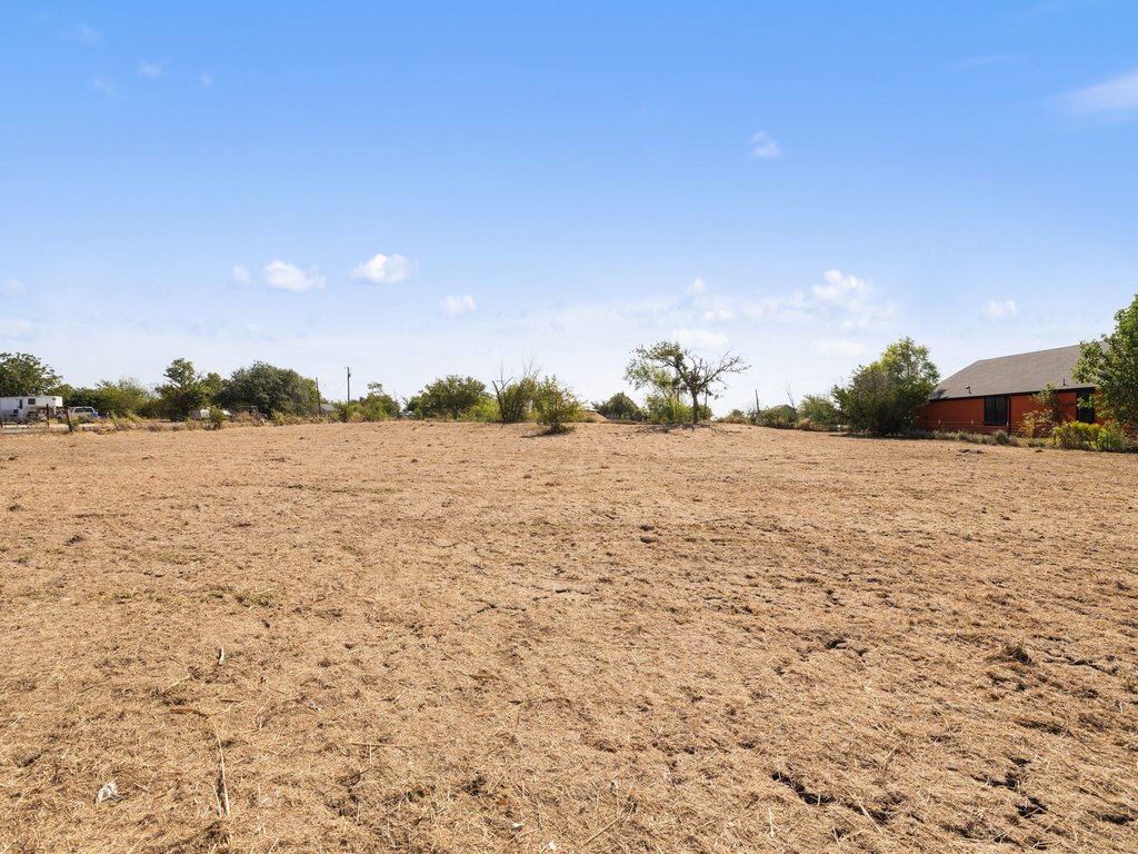 20416 Wilson Road Coupland, TX 78615 - Photo 39 of 39 Generous open acreage offers a versatile canvas under expansive blue skies.
