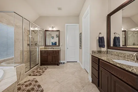 a spacious bathroom with a granite countertop sink and a mirror