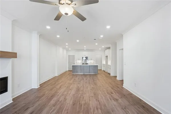 a view of a house with wooden floor and a ceiling fan