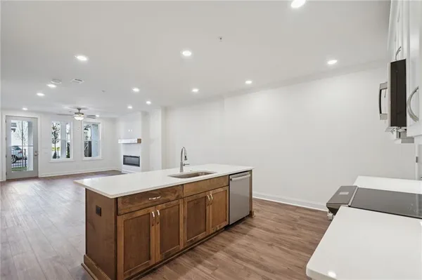 a kitchen with a sink and wooden floor