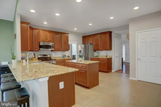 a view of a dining room with furniture and a large window