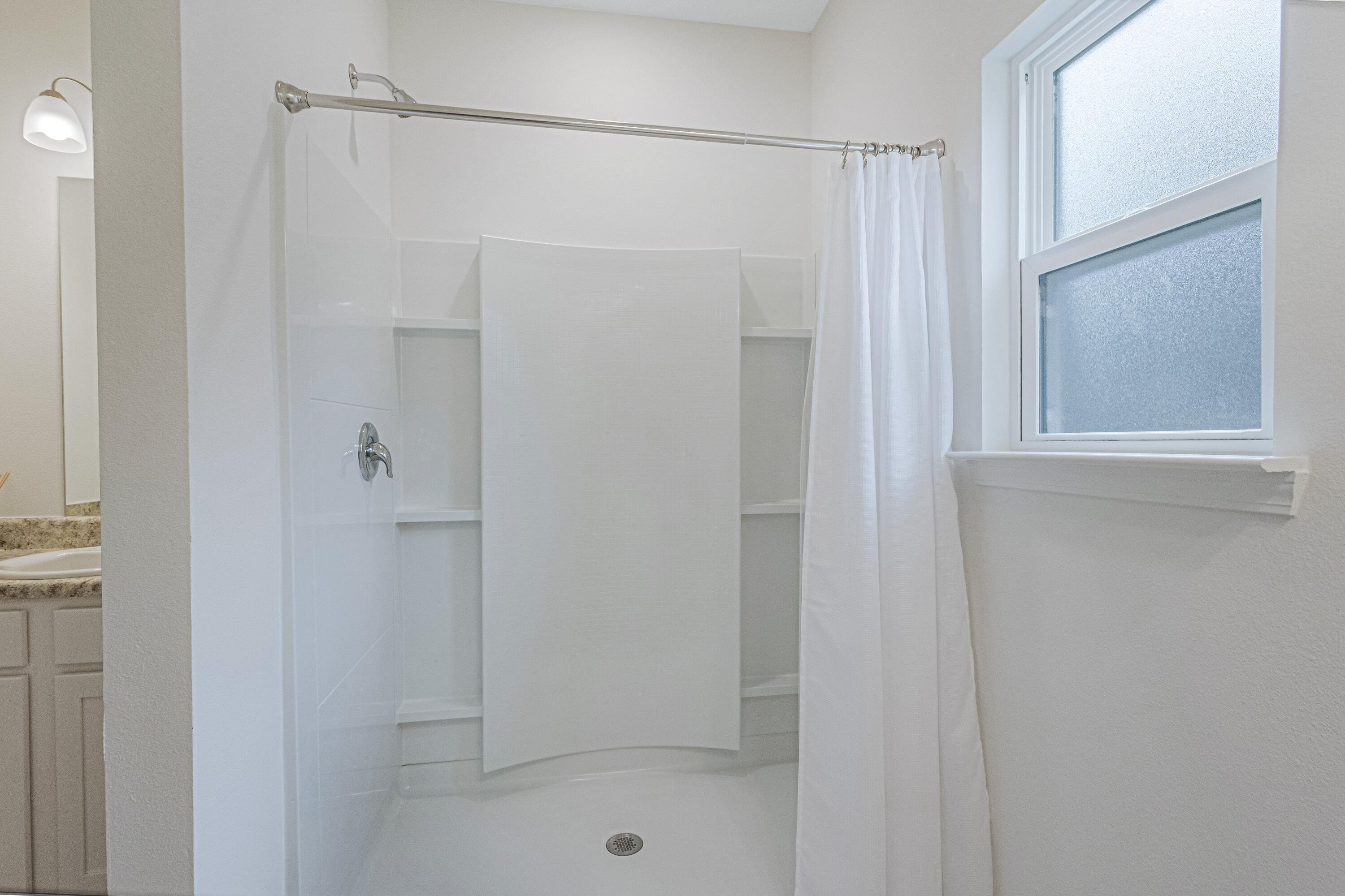 16 Woodsorrel Street Freeport, FL 32439 - Photo 13 of 23 a bathroom with a glass shower door