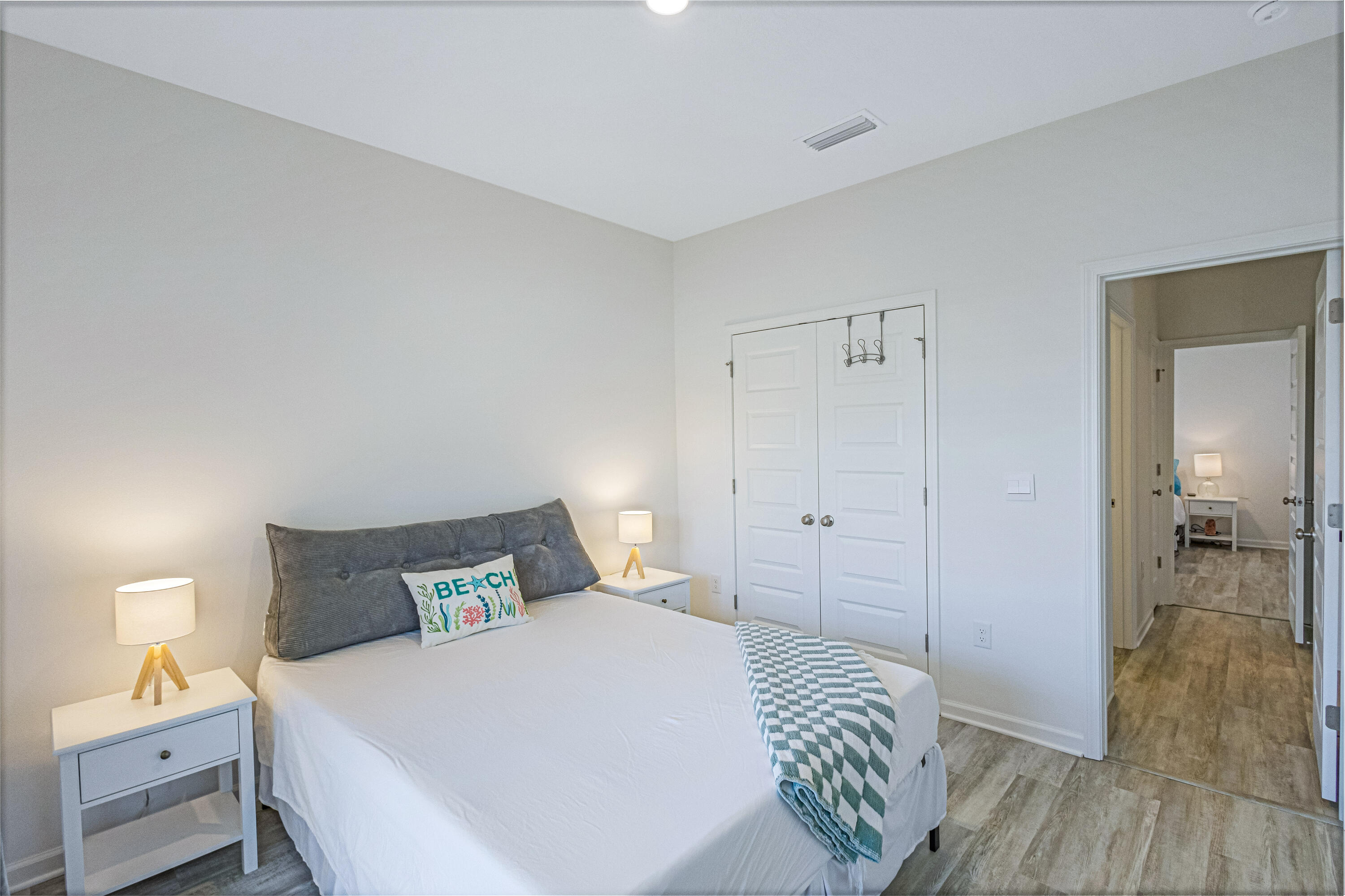 16 Woodsorrel Street Freeport, FL 32439 - Photo 15 of 23 a bedroom with a bed and a lamp