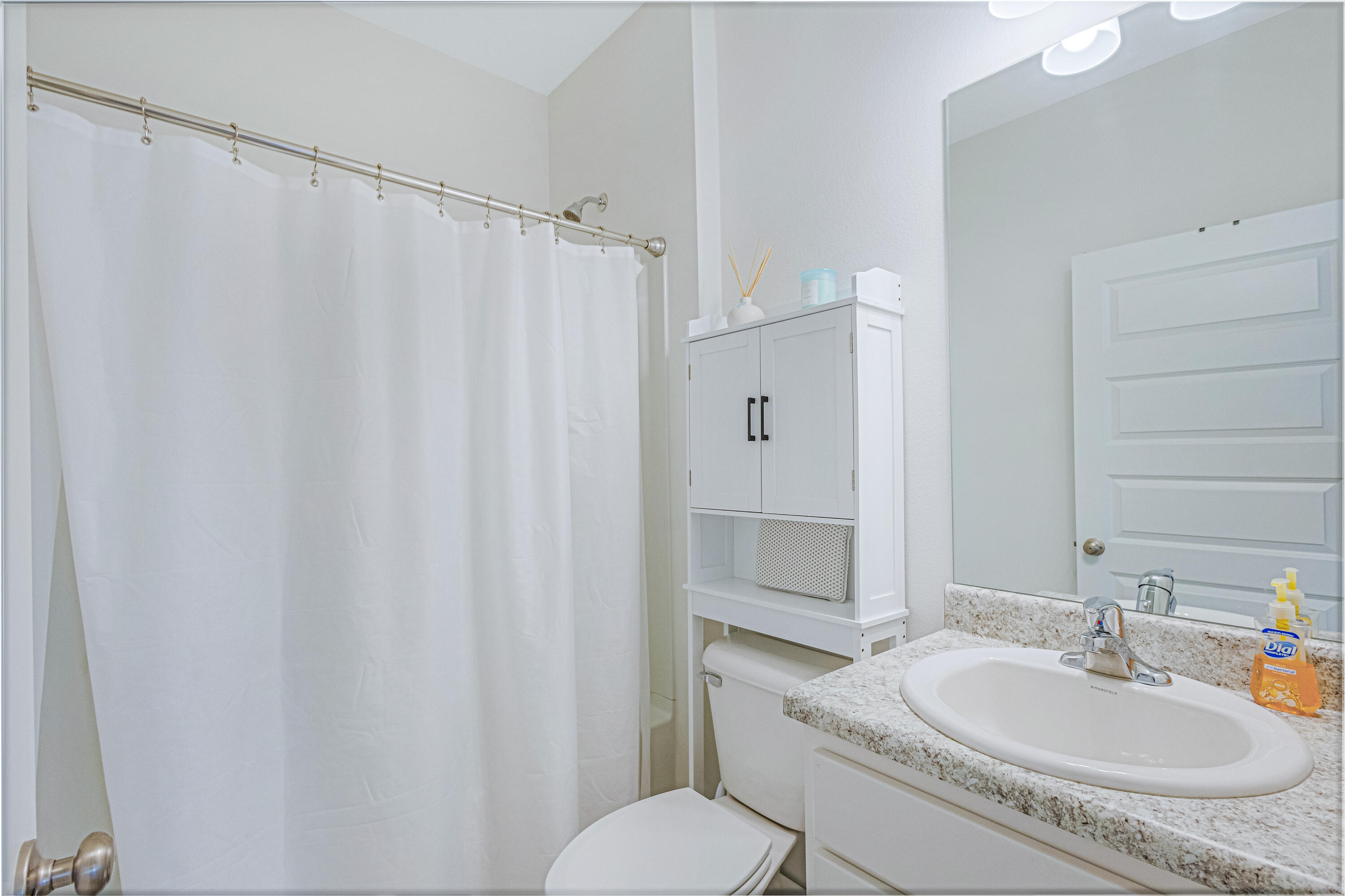 16 Woodsorrel Street Freeport, FL 32439 - Photo 16 of 23 a bathroom with a granite countertop sink and a mirror